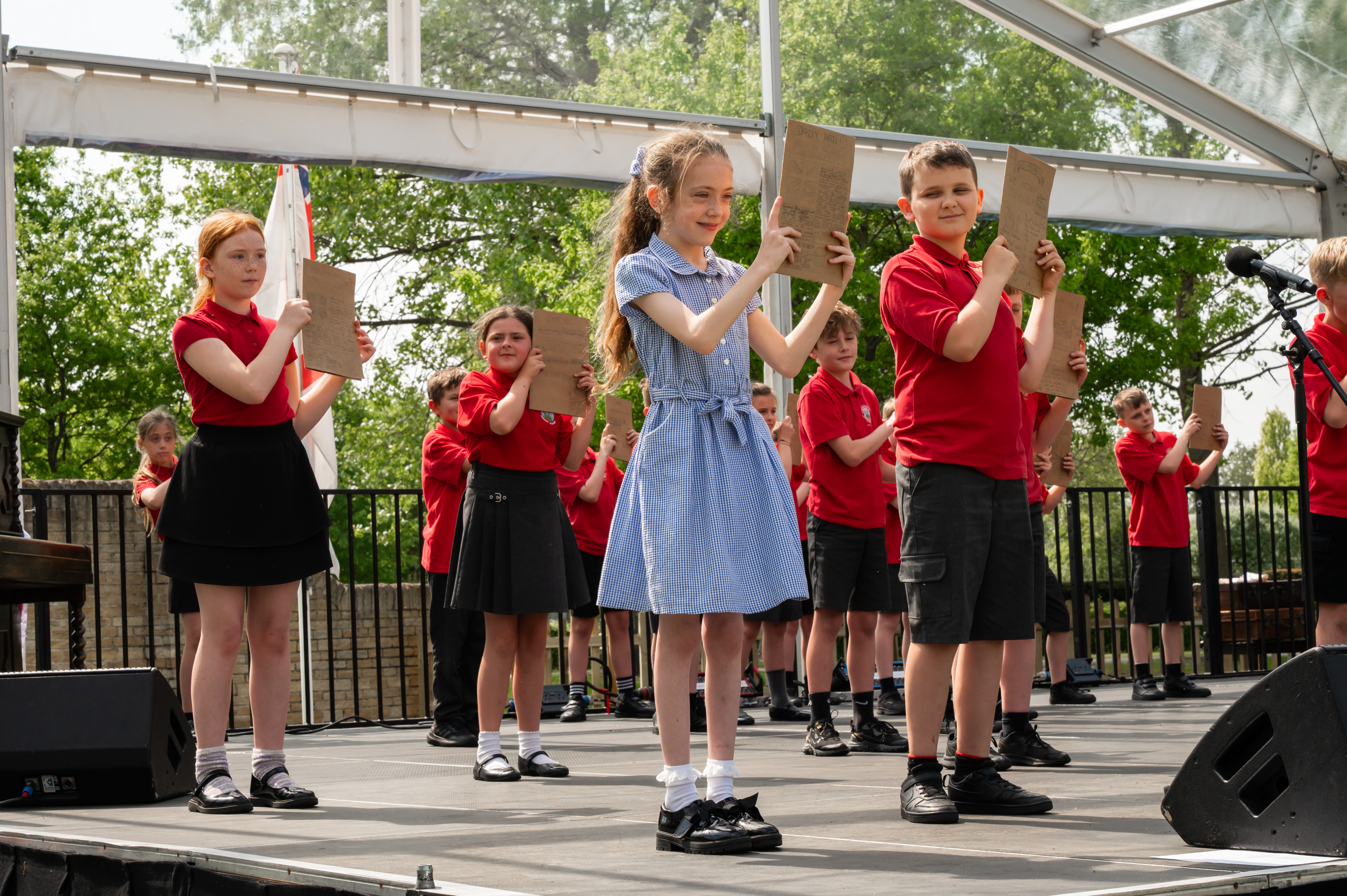 School children on stage at the Arboretum, performing as part of our 2025 schools project surrounding VE Day 80.