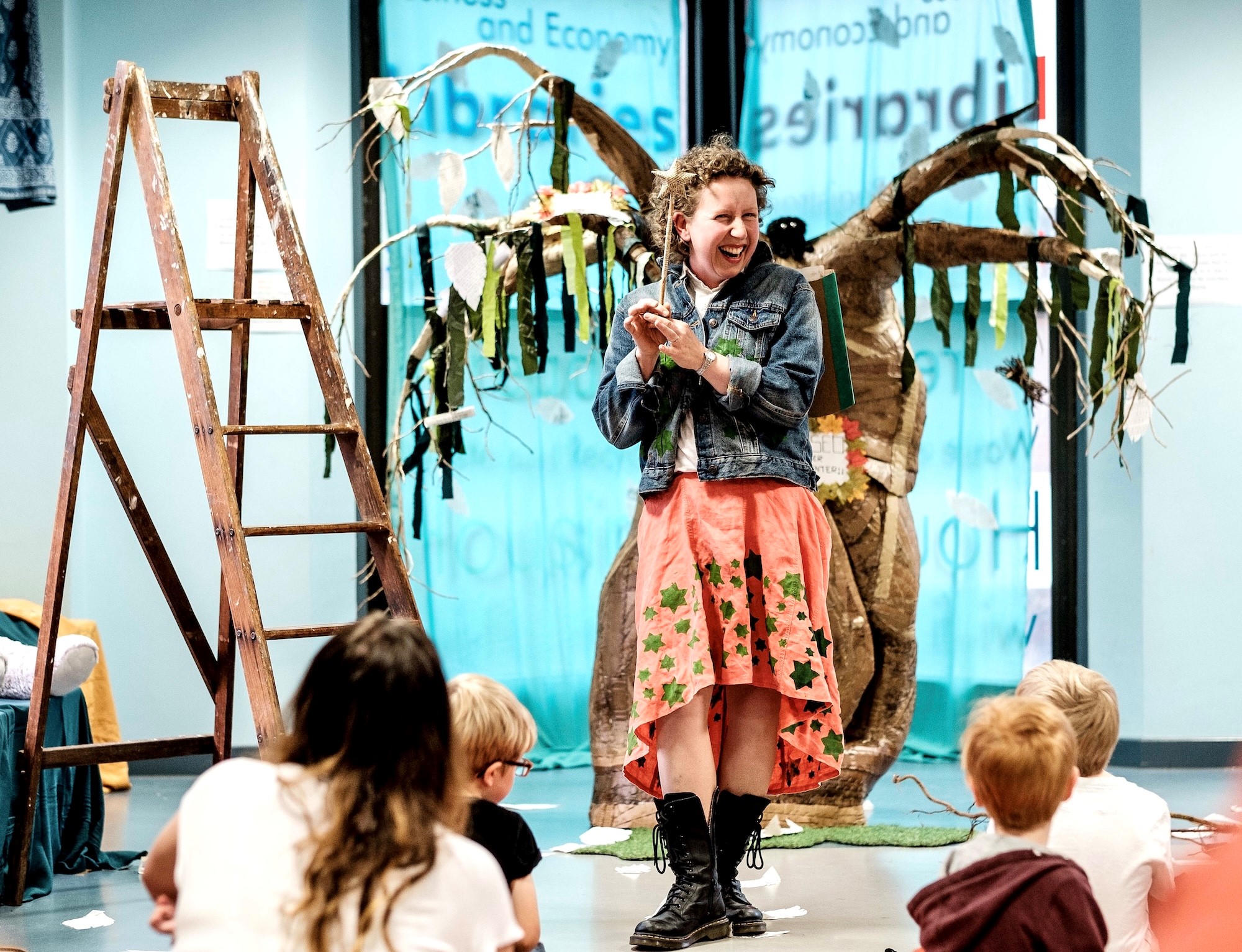 a performer in costume as part of Alice and the Library Tree