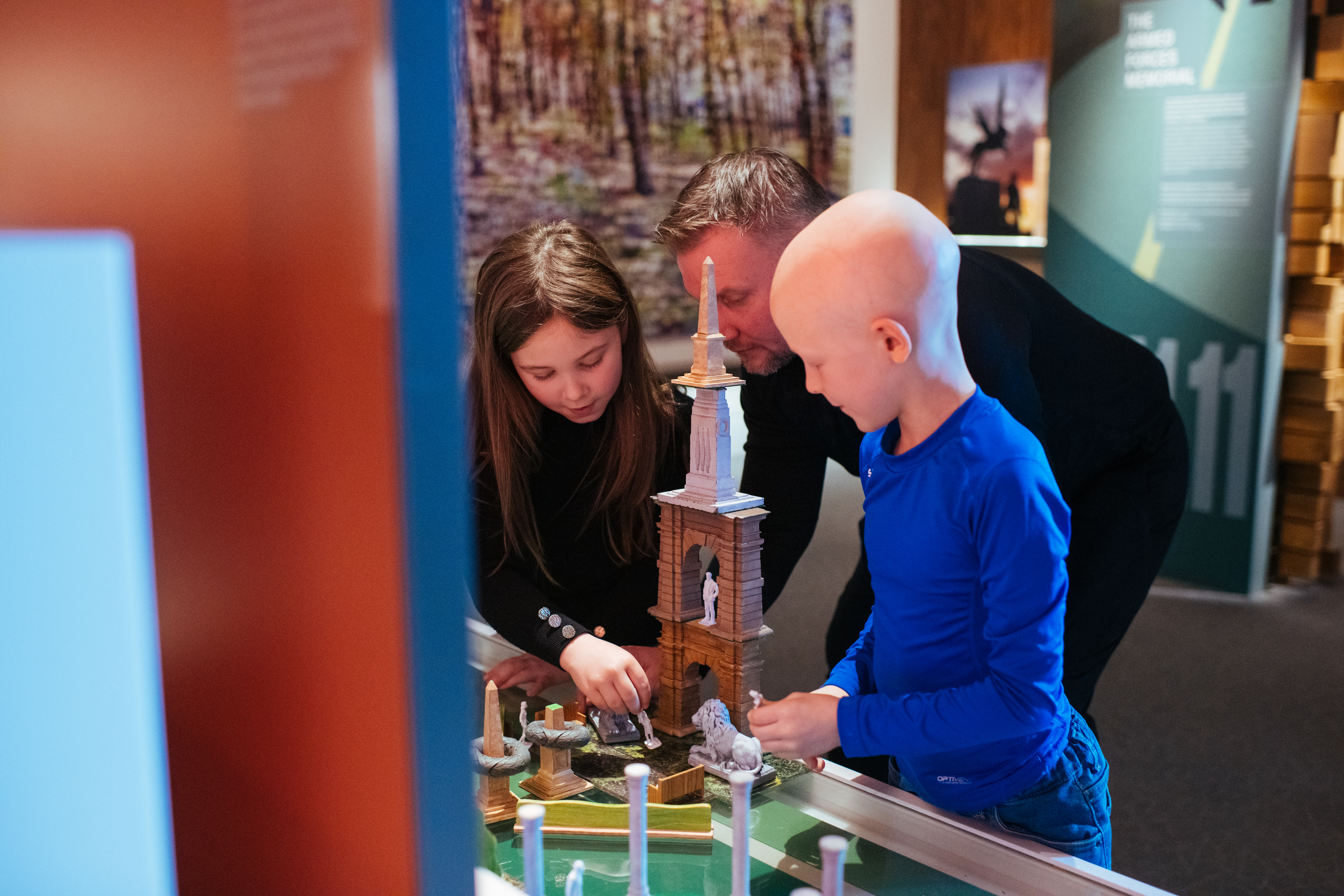 Two children building memorials within our interactive Landscapes of Life Exhibition