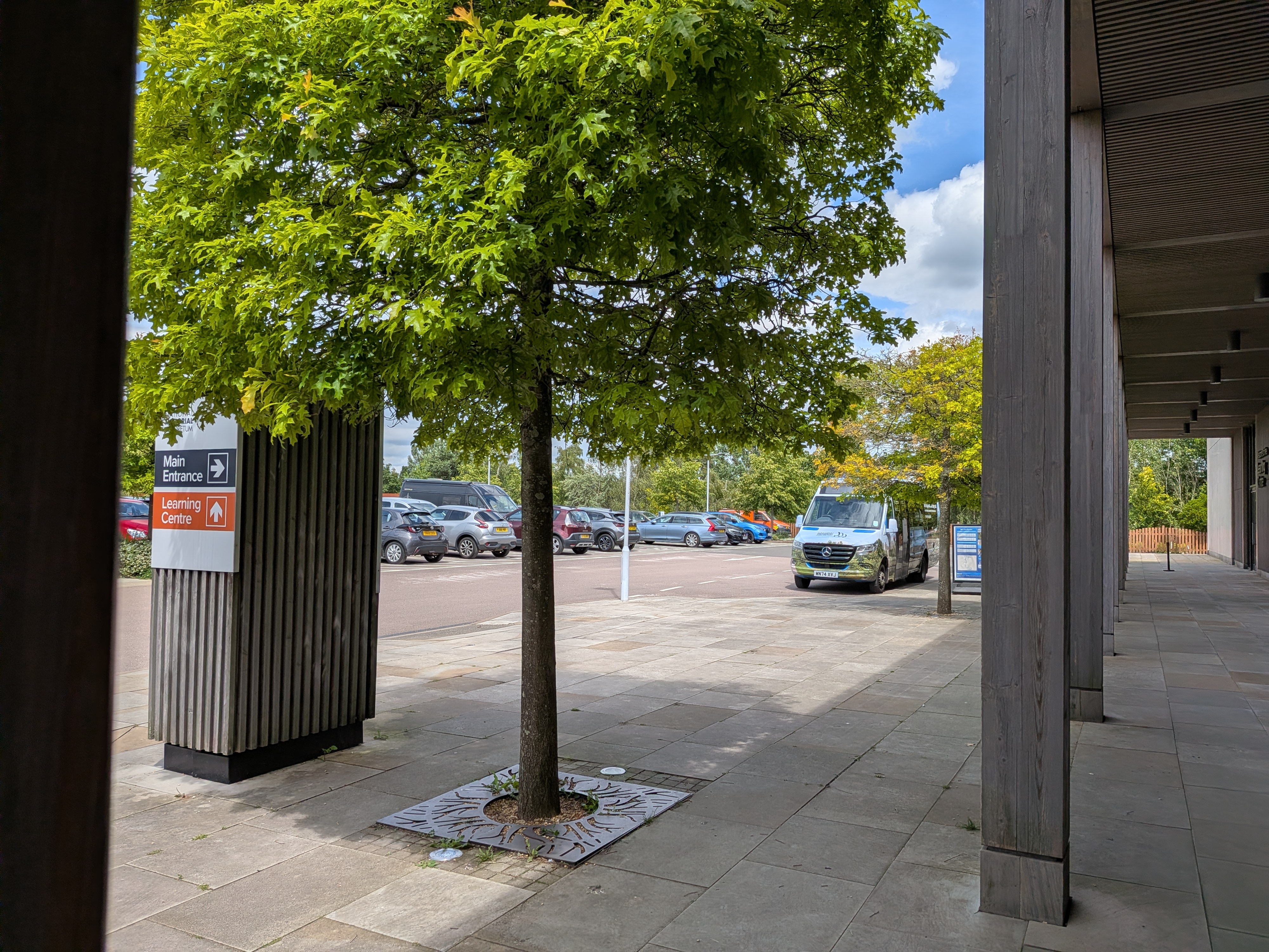 Bus Drop Off at the Arboretum, showing one bus pulled up outside the Arboretum building