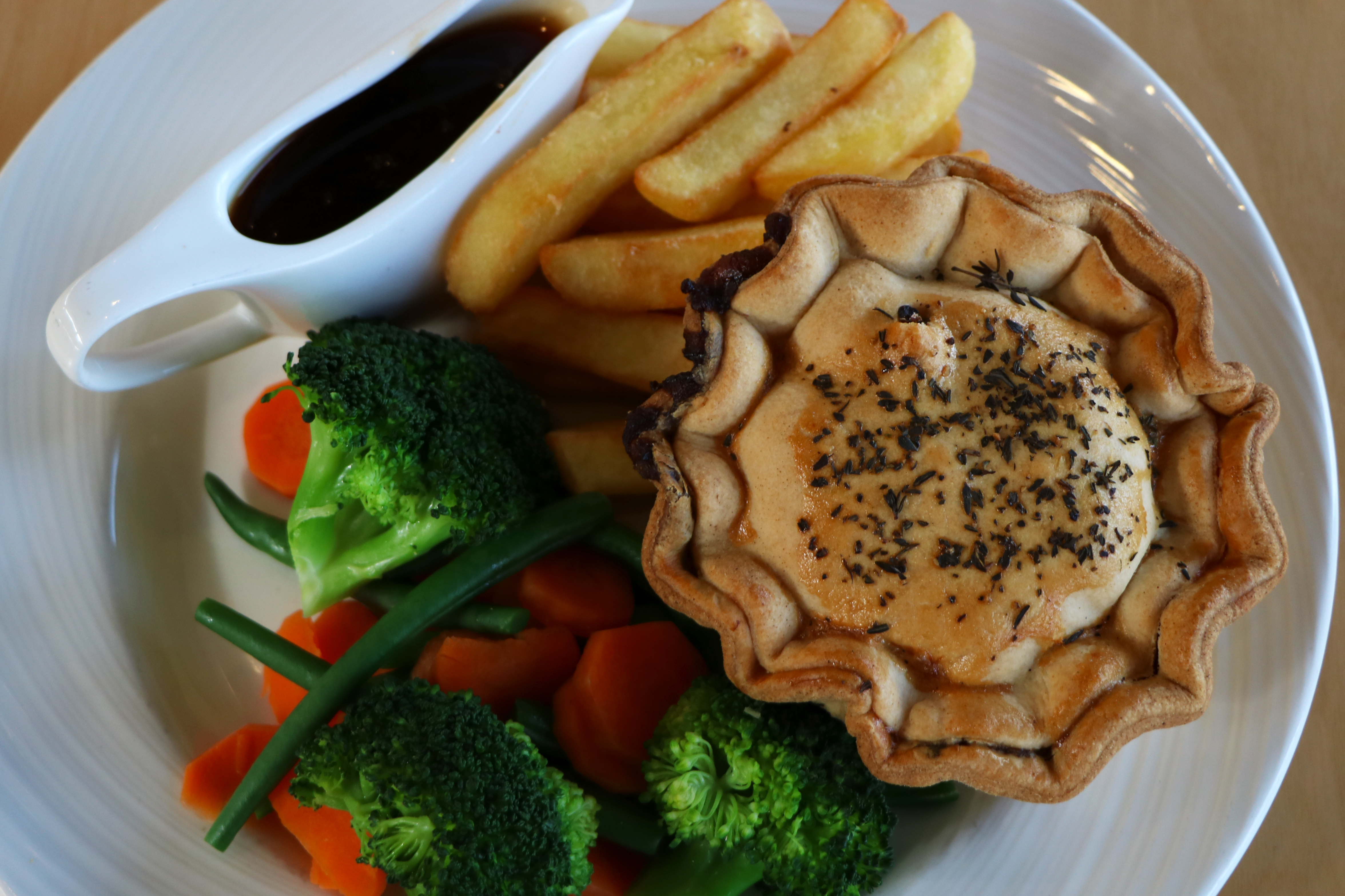 A plate of pie and chips, peas and gravy, prepared by the Arboretum chefs.