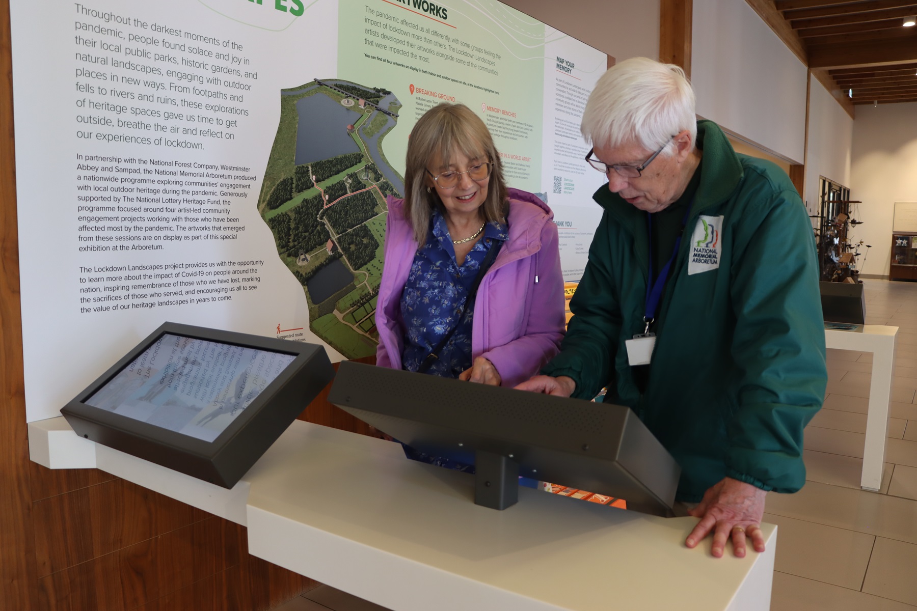 Visitors using the Arboretum Kiosk to find a memorial
