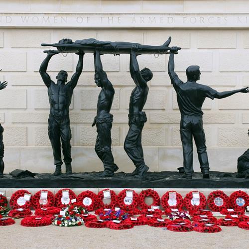 Statue on the Armed Forces Memorial with Poppy Wreaths surrounding it