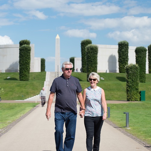 Couple enjoy walking in front of Armed Forces Memorial